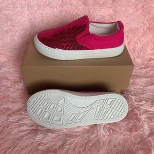 Little girls pink sparkly shoes.